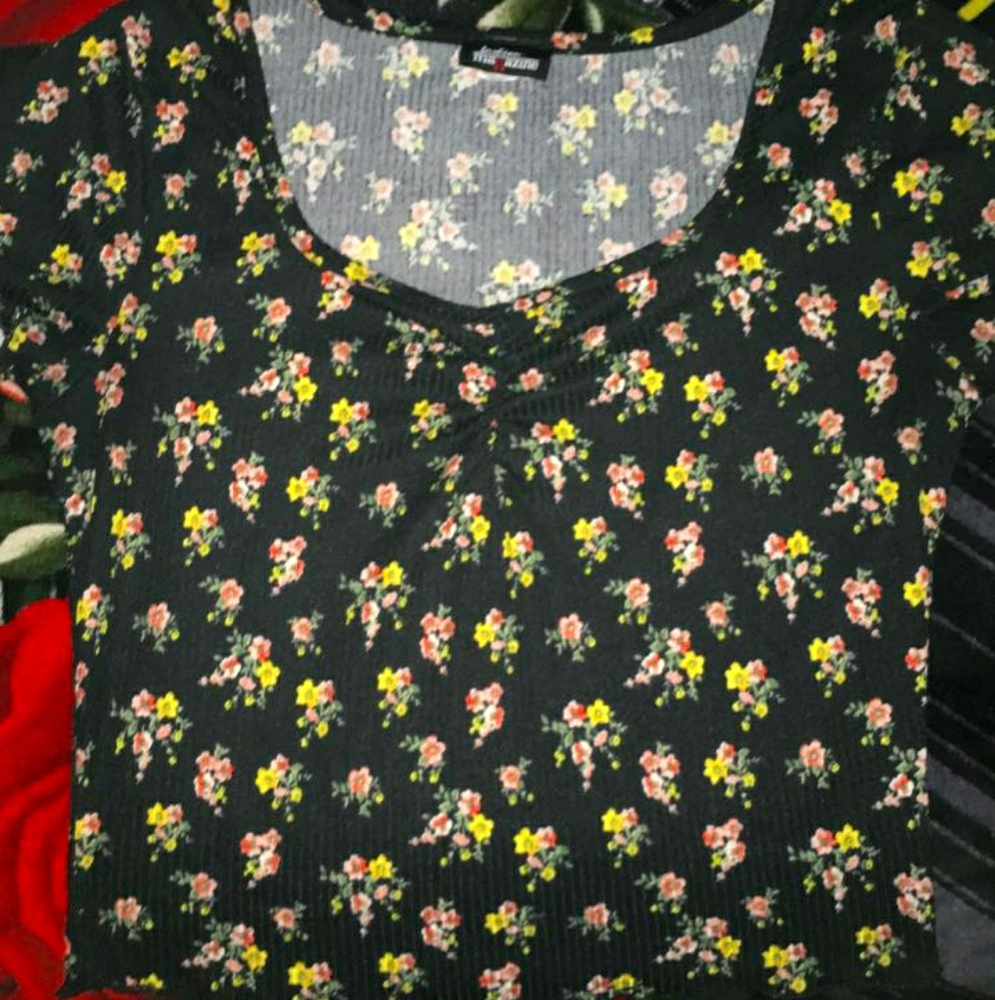 A black crop top with flowers prints on it